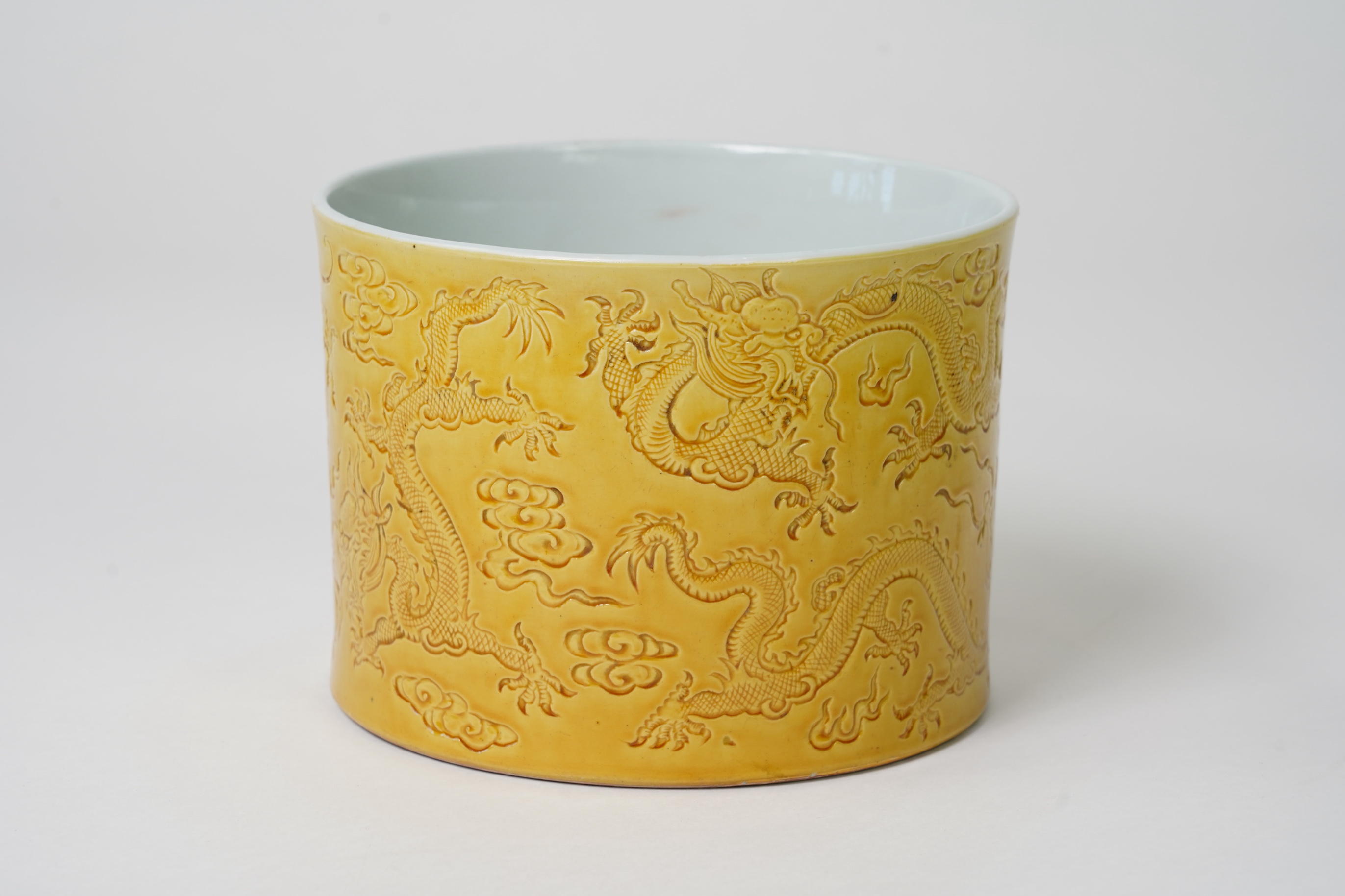 A Chinese yellow glazed 'dragon' brush pot, possibly Republic period